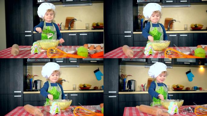 兴奋的蹒跚学步的女孩在厨房玩面粉