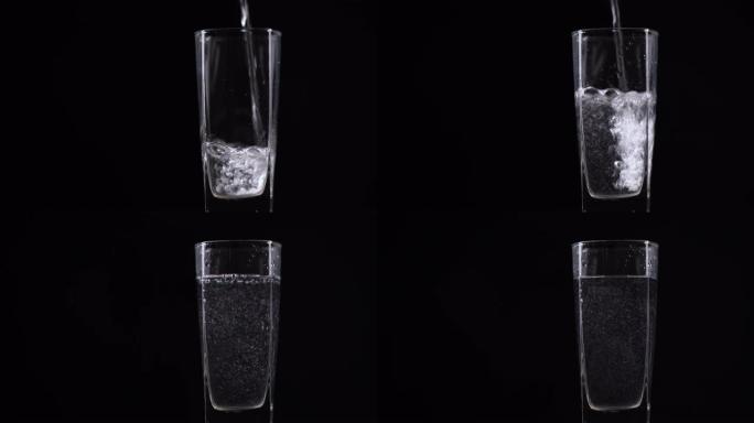 将新鲜的矿泉水倒入桌子上的玻璃杯中。黑色背景上带有氧气球的新鲜起泡饮料