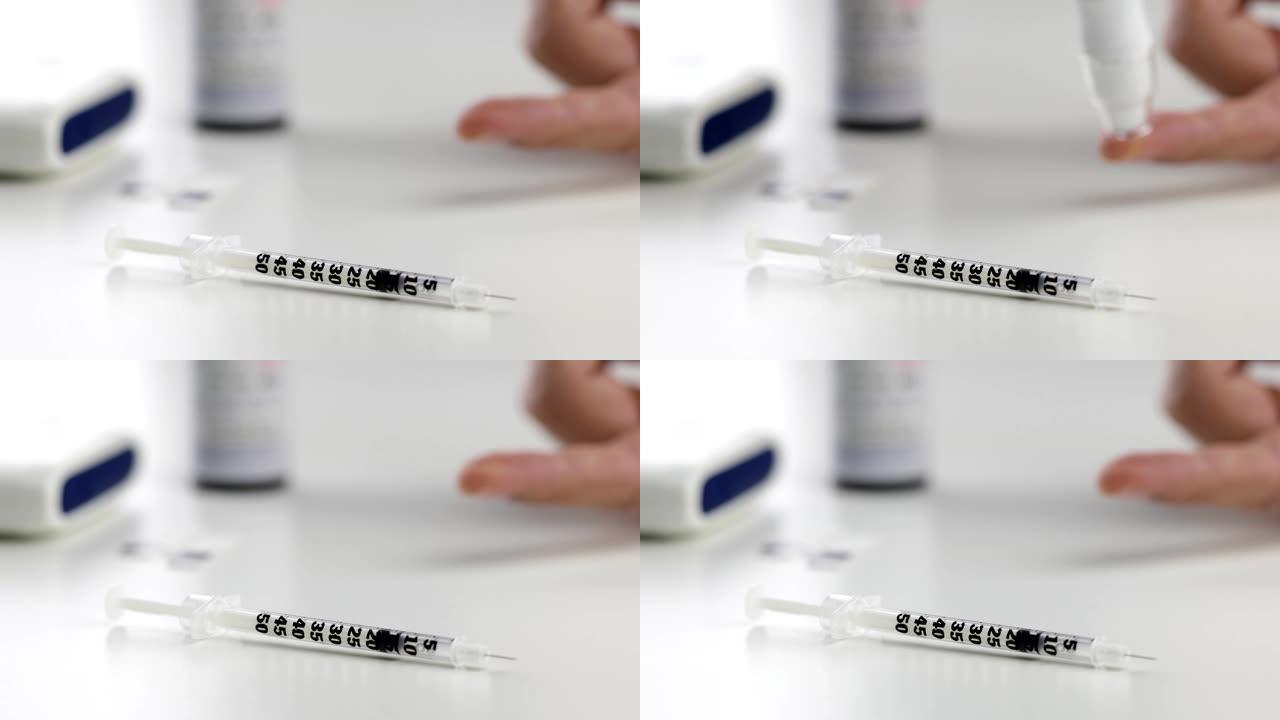 前景上的胰岛素注射器，背景上的模糊血液测试