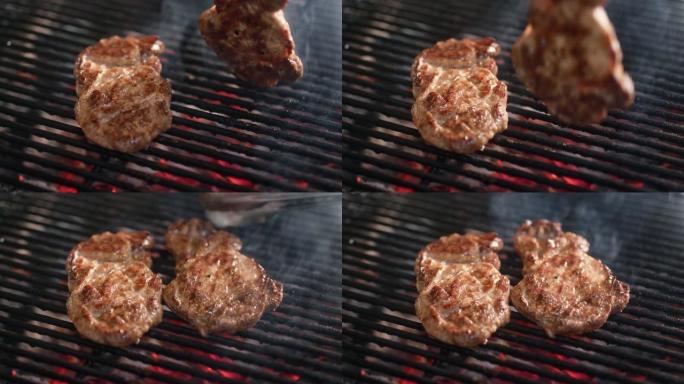 用钳子烹饪食物，用木炭将煎炸肉块扔在烤架上。