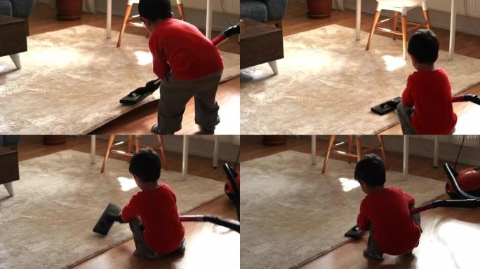 用吸尘器清洁地板的小男孩