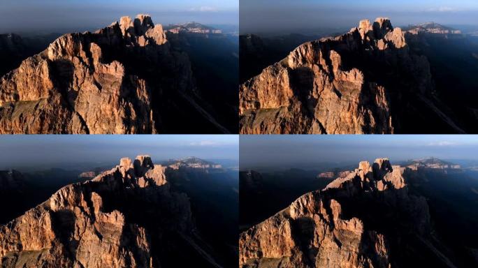 日落时无人机飞越尖锐的岩石露头的鸟瞰图。用于极端登山的陡峭的岩层山。飞行穿越旅行视频