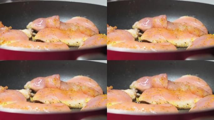 生鸡肉，用香辛料在平底锅里油炸的鱼片。咖喱的辣味，烹饪