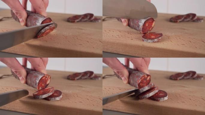 厨师将西班牙传统自制的choriso香肠切成小块放在木制切菜板上
