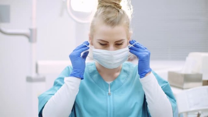 牙医在手术前戴上防护口罩