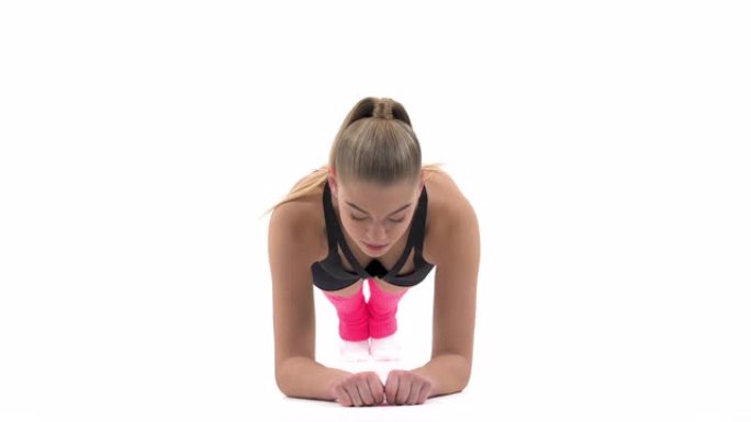 专业女运动员进行困难的体操练习 (木板练习) 的特写镜头。专业运动常规概念