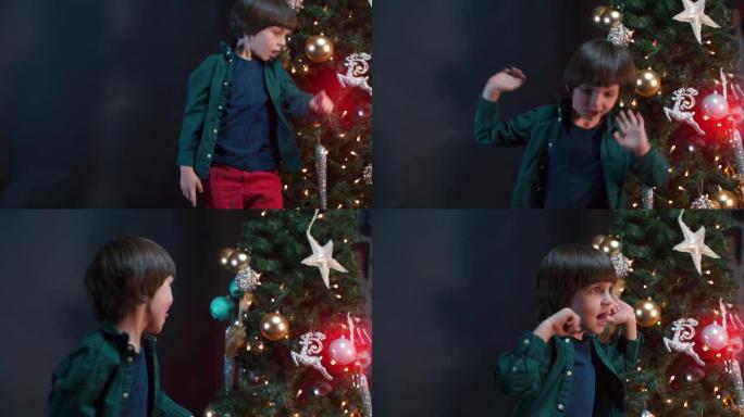 这个男孩在新年树附近的圣诞节礼物中欢欣鼓舞。
