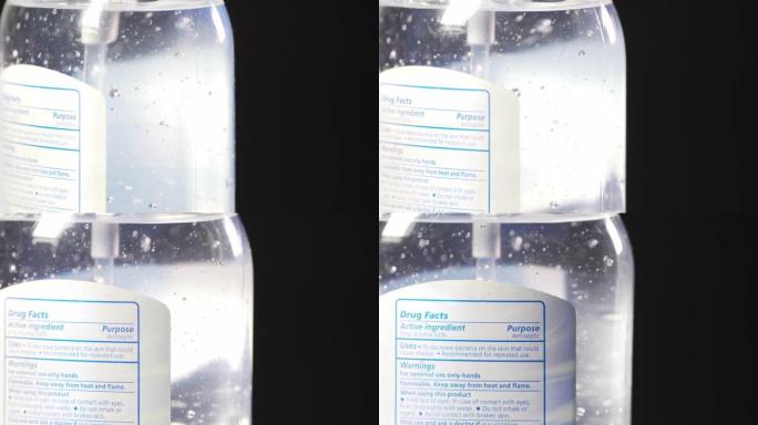 特写移动旋转揭示标签在一瓶凝胶洗手液上拍摄标签，酒精和芦荟在灰色背景下防止COVID传染性非典型肺炎