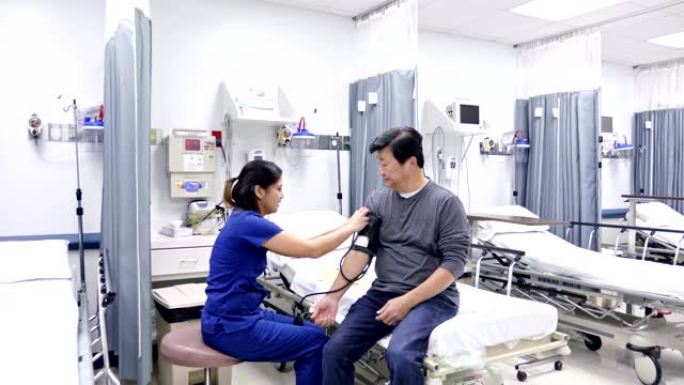 Emergency room nurse checks a senior patient's blo