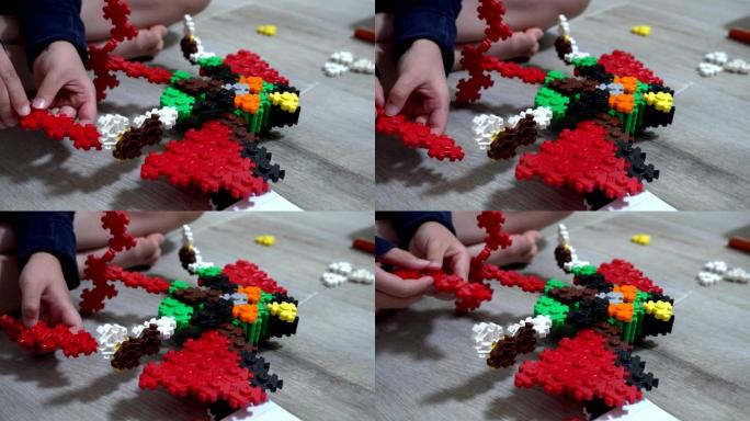 小孩子在室内玩许多彩色塑料玩具。专注于机器人形状的玩具。
