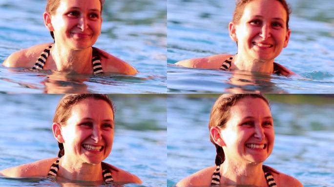 快乐的女人真正的微笑在游泳池的水