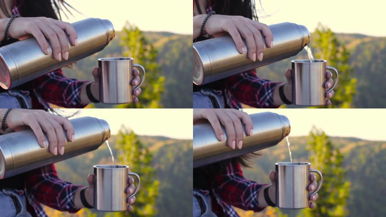 年轻女子从山上的热水瓶里倒热茶