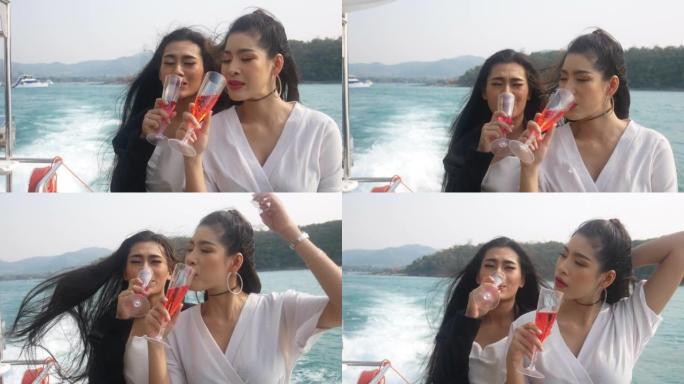 美丽的亚洲年轻女子在泰国的快艇上旅行和喝酒。