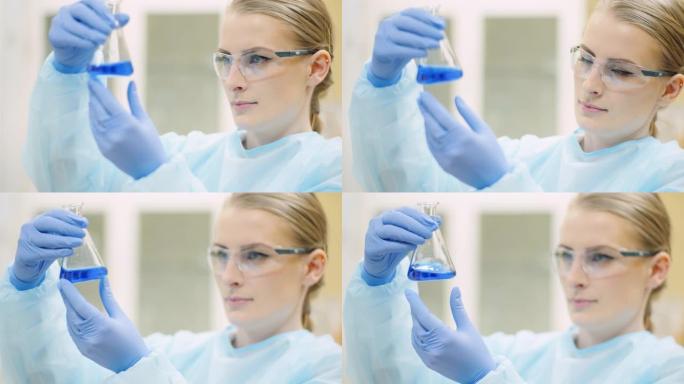 带移液器的女科学家在实验室分析液体