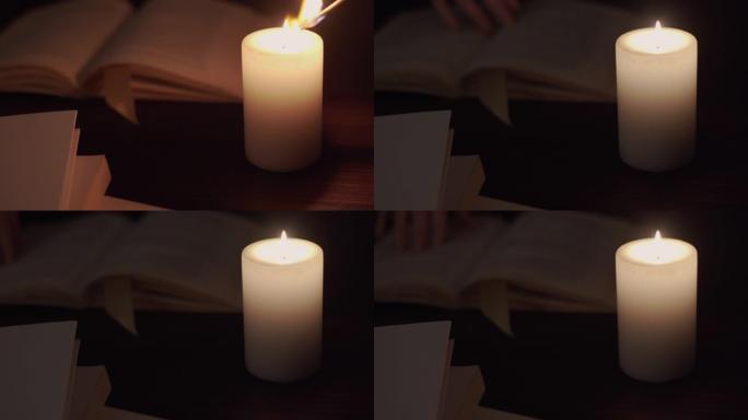 通过照亮书本和一个女人的手在书页上翻阅，在弱光下点燃蜡烛的特写镜头-prores日志