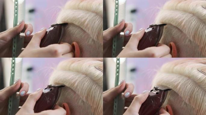 理发师用修剪器剪金发女客户。短小的小精灵发型和剃光的太阳穴。