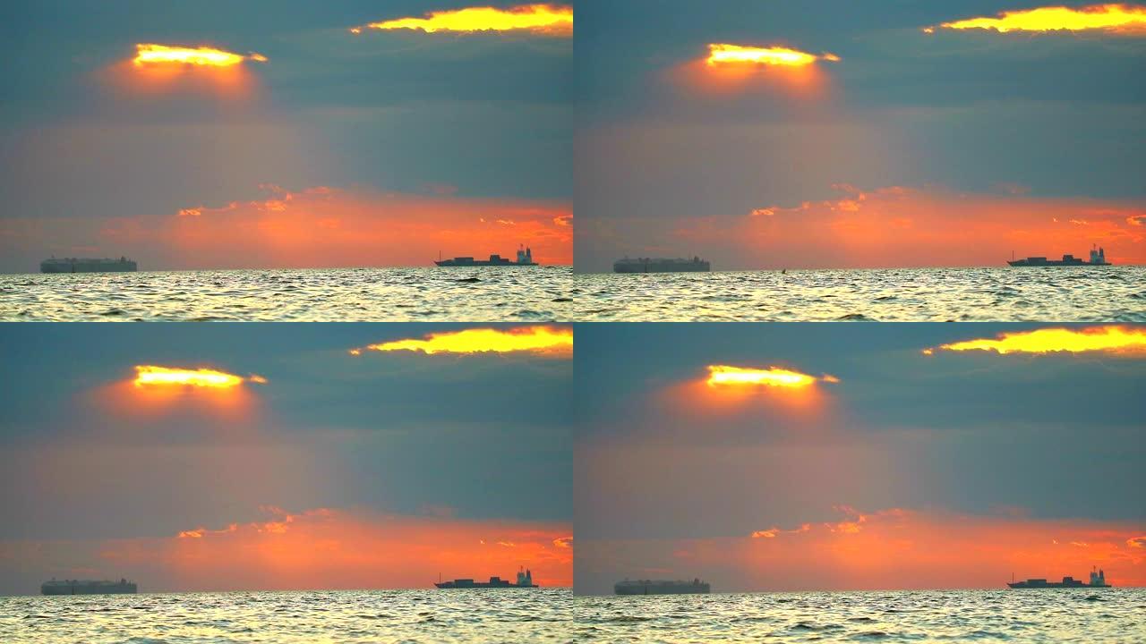 海上和货船上的日落红橙云