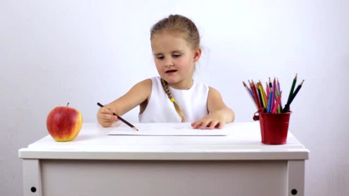迷人的女孩用铅笔在专辑上画画心情很好