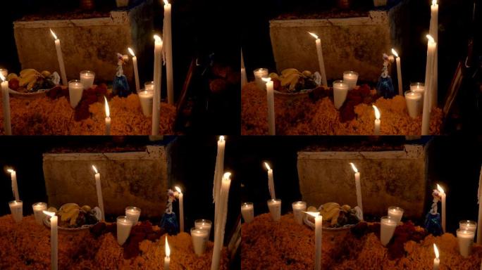 亡灵节期间坟墓顶上的新鲜水果和蜡烛