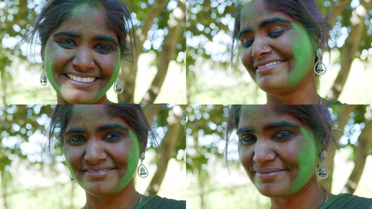 印度妇女特写脸部涂满明亮的胡里节颜色