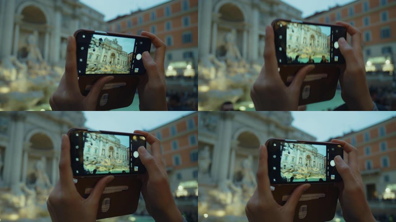 人们用手机拍摄特雷维喷泉的照片