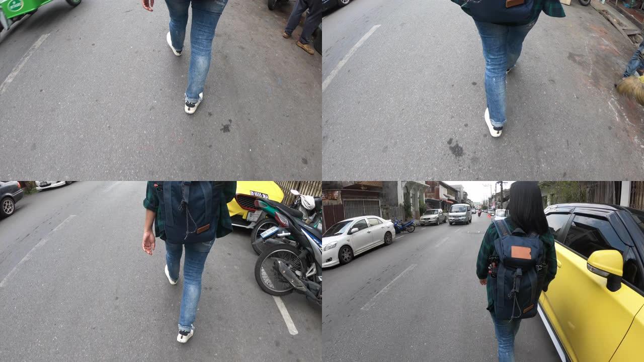在城市街道上行走的特写脚穿帆布鞋
