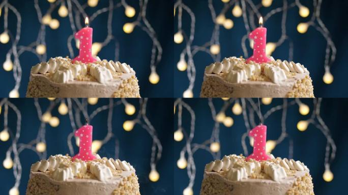 蓝色背景上有1号粉色蜡烛的生日蛋糕。蜡烛吹灭了。慢动作和特写视图