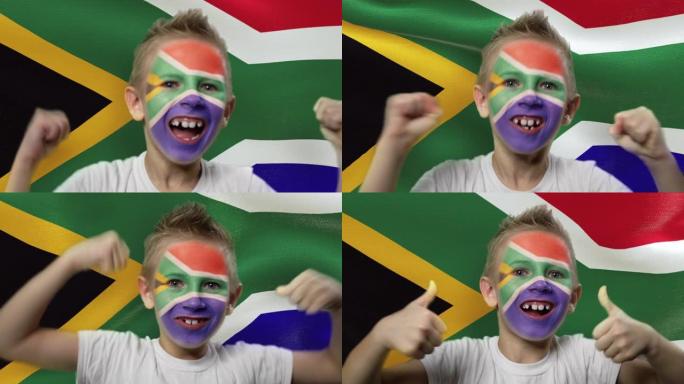 南非国旗背景上的快乐粉丝。有着民族色彩的脸的快乐男孩。