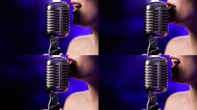 女歌手在蓝色背景上的麦克风上唱歌，特写嘴唇侧视图