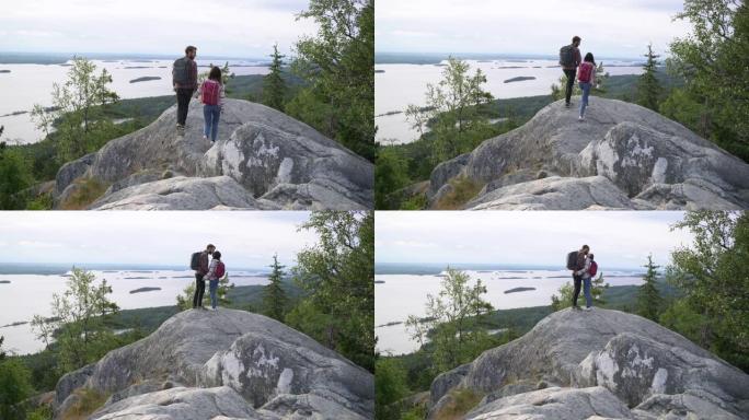 夫妇在努伊斯基奥国家公园的岩石上散步，可以看到湖景