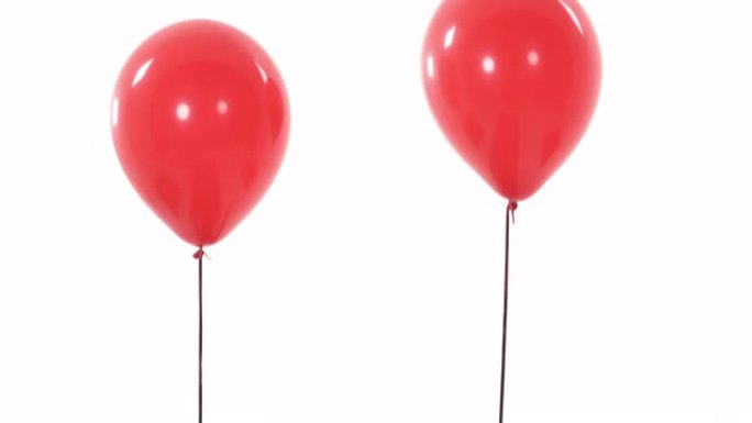 两个红色气球飞起来并从摄像机视野中消失的特写演示视频。孤立，在白色背景上