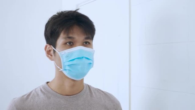 男人使用保护面罩保护新型冠状病毒肺炎病毒在家里。