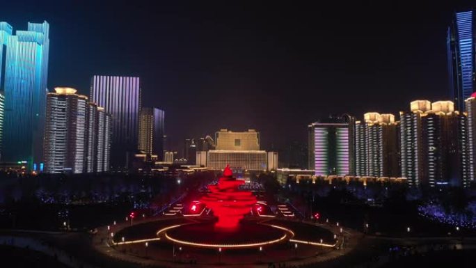 青岛市夜间照明秀市中心著名海岸线广场空中全景4k中国