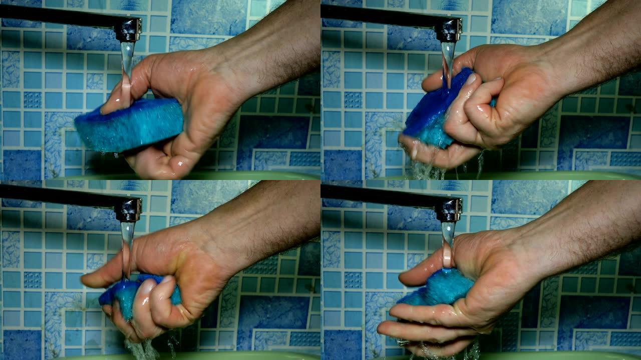 人的手洗和漂洗毛巾，用于在流水下洗碗。