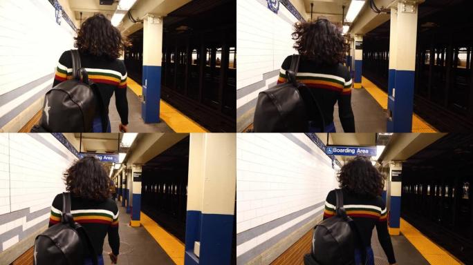 纽约地铁地铁站年轻混血千禧一代女孩行走的慢动作稳定凸轮镜头。