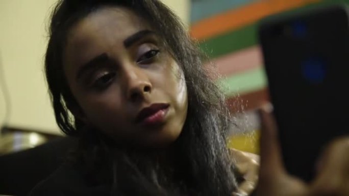 年轻美丽的中东女孩使用手机和自拍