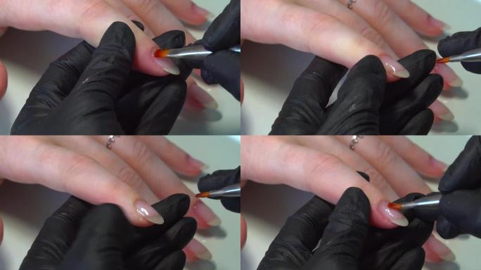 透明抛光应用过程。美甲师戴着黑色手套，用无色清漆覆盖女性指甲。美甲沙龙中的美甲。大师用指甲油涂指甲。