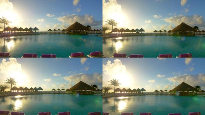 热带海滩跟踪镜头上的无边泳池带雨伞