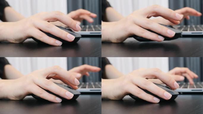 女人用电脑鼠标的手，额外的特写。女性手指在办公室用笔记本电脑键盘和鼠标打字。商业概念
