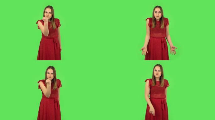 穿着红色连衣裙的温柔女孩用拳头威胁着。绿屏