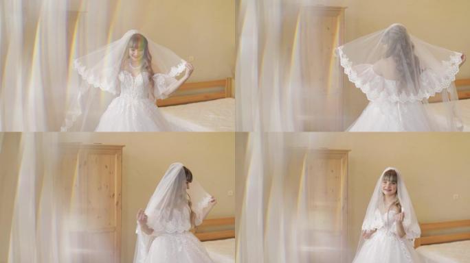 美丽可爱的新娘穿着婚纱靠近窗户。漂亮女人