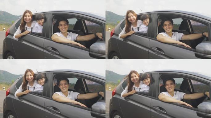 幸福的亚洲家庭，父亲，母亲和女儿在紧凑型汽车上微笑着开车去度假。汽车保险或租赁和家庭快乐的旅程概念。