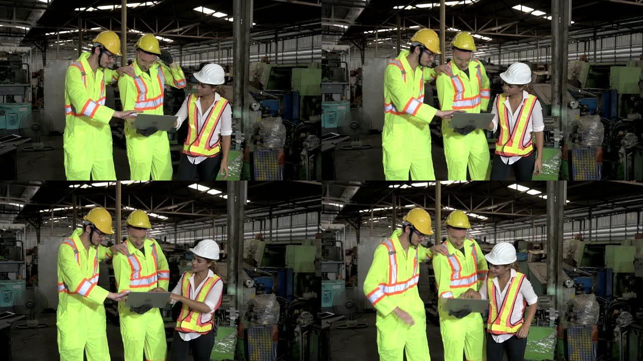 一名混血女性和两名白人男性工程师在工厂区工作。