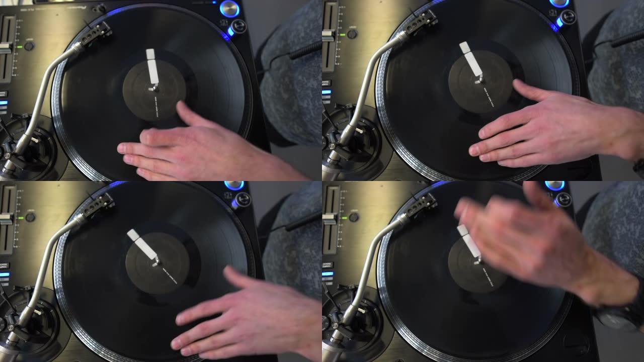 专业DJ在制作工作室混合模拟黑胶唱片。艺人在派对上手纺圆音乐唱片