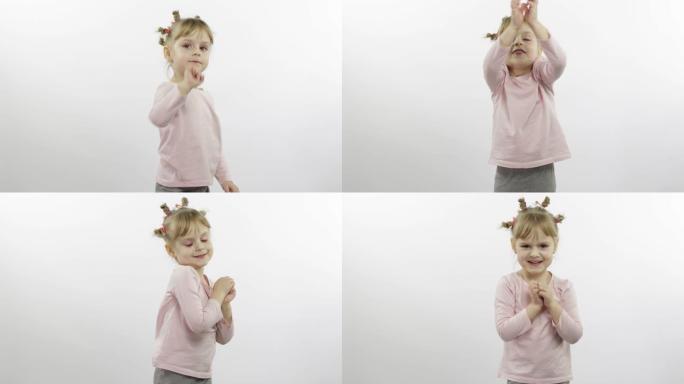 穿着粉色上衣跳舞的积极女孩。快乐的四个小孩。白色背景