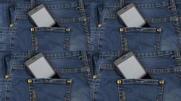 Zoom。智能手机从牛仔裤的后口袋里伸出来。商业和时尚