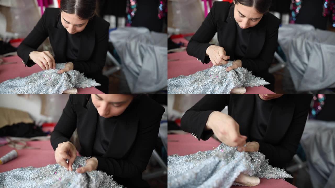 一名妇女用手缝制