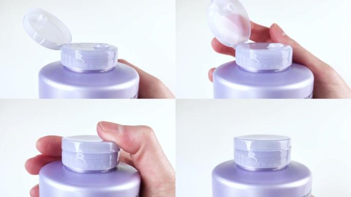 手指关闭紫色瓶子的盖子