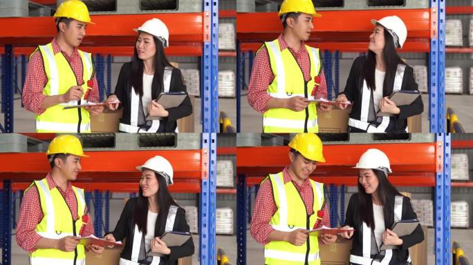 戴着安全帽的员工男女使用数字teblet检查仓库中的库存，成功，握手，拳头碰撞