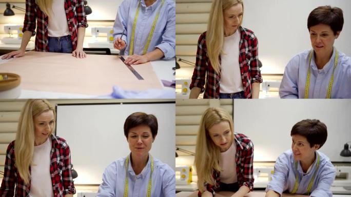 微笑中年女裁缝的上下倾斜中镜头向年轻学生解释如何在车间的桌子上绘制纸质缝纫图案